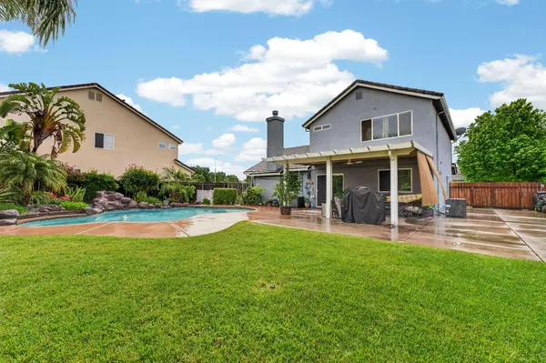 a view of a house with a yard and sitting area
