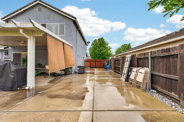 a view of a house with backyard and sitting area