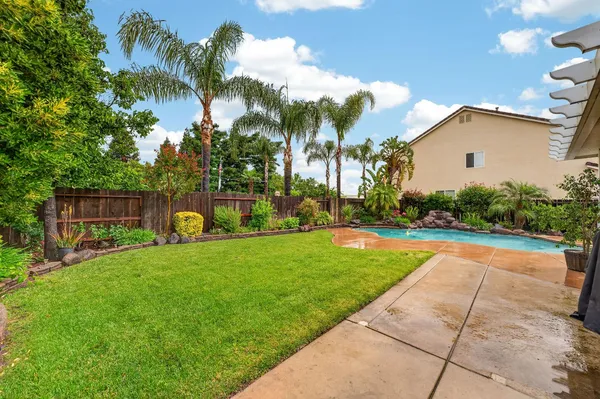 a view of a backyard with swimming pool