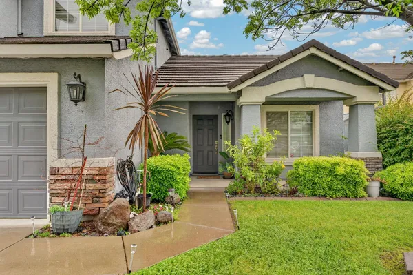 front view of a house with potted plants
