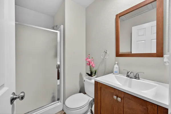 a bathroom with a sink vanity mirror and toilet