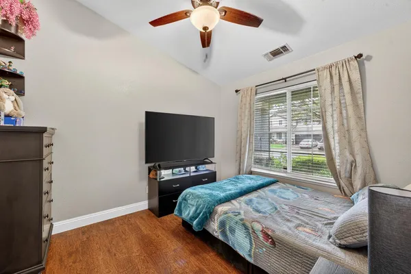 a bedroom with a bed and a flat screen tv