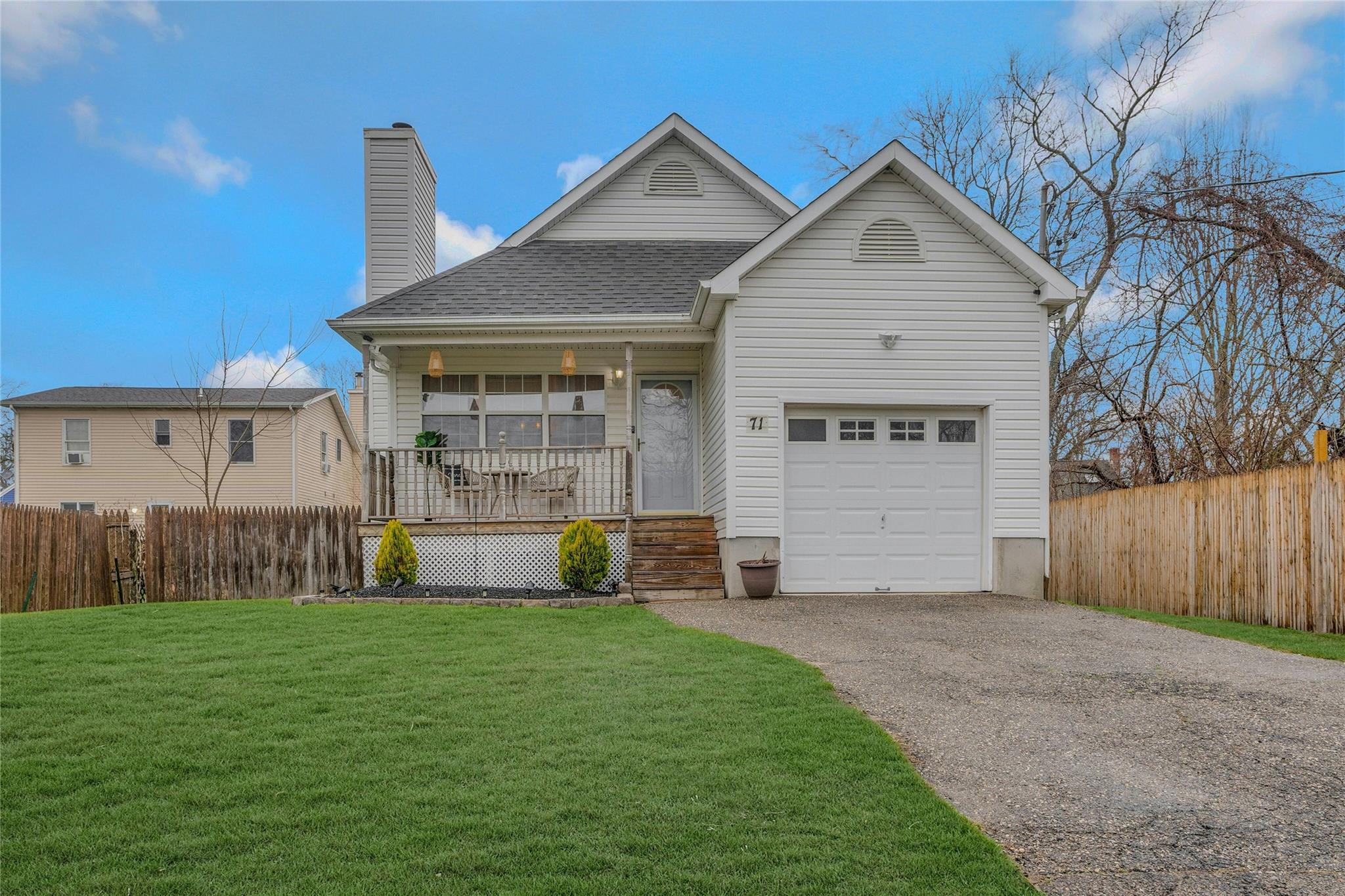 71 Shore Drive Mastic Beach, NY 11951 - Photo 1 of 1 a front view of house with yard and green space