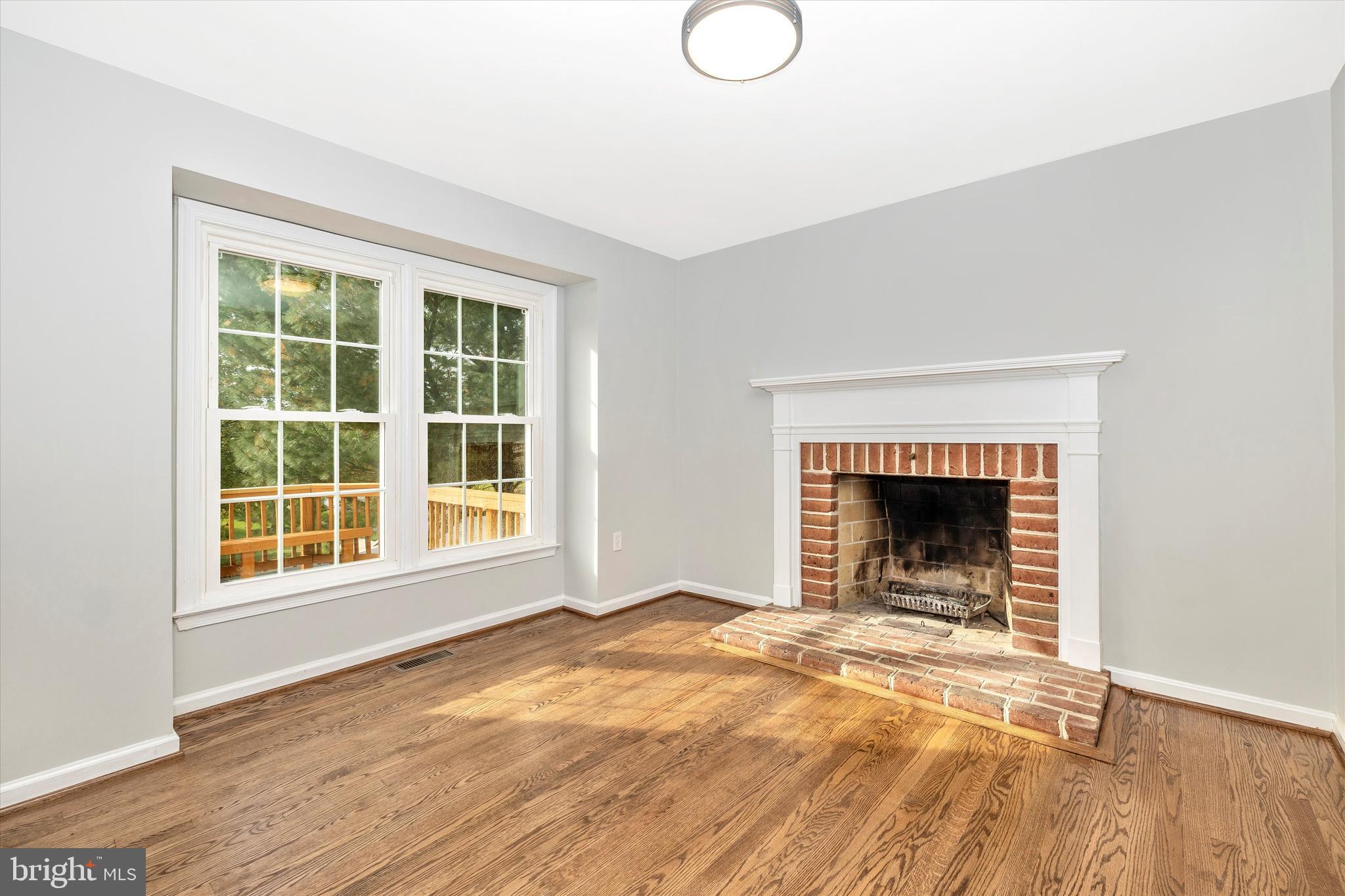 8001 Hollow Reed Court Frederick, MD 21701 - Photo 13 of 33 a view of an empty room with a window and a fireplace