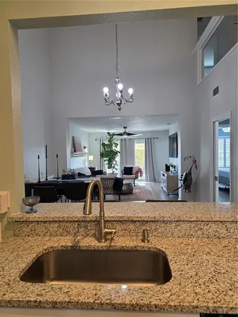 a kitchen with stainless steel appliances a refrigerator a sink dishwasher a stove and white cabinets with wooden floor