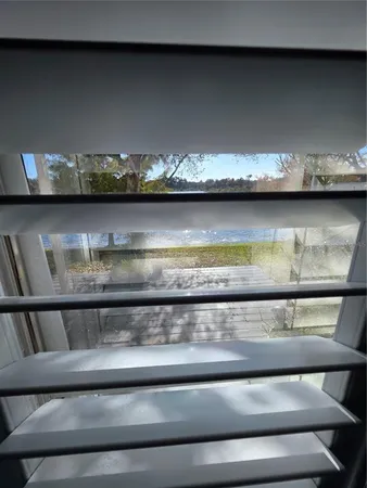 a bathroom with a sink a toilet a mirror and shower curtain