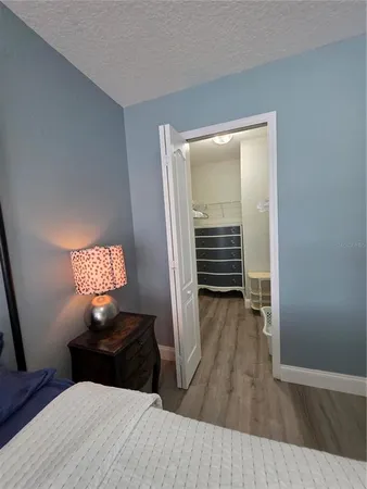 a bedroom with a large bed and a chandelier