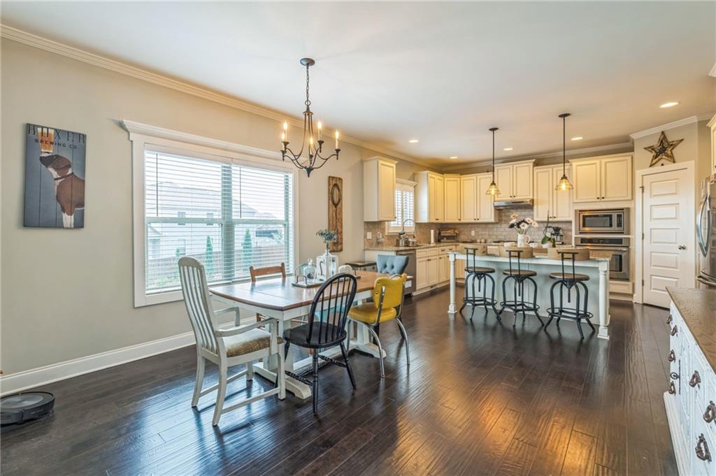 1621 Highland Creek Drive Monroe, GA 30656 - Photo 11 of 54 a view of a dining room with furniture window and wooden floor