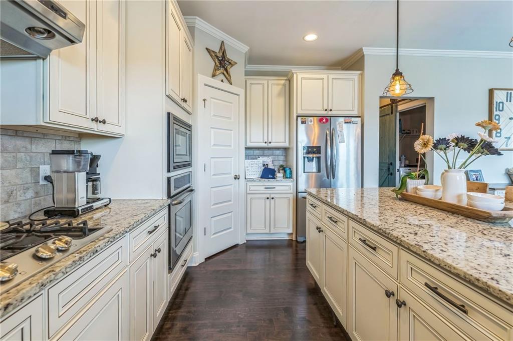 1621 Highland Creek Drive Monroe, GA 30656 - Photo 13 of 54 a kitchen with stainless steel appliances granite countertop a stove a sink and a refrigerator