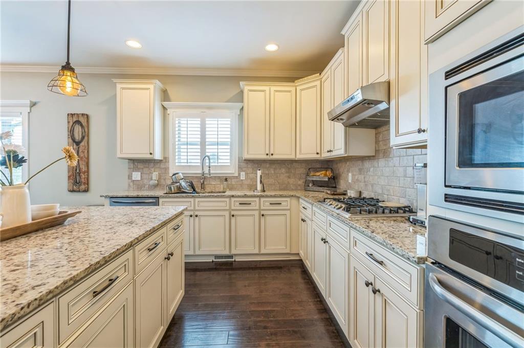 1621 Highland Creek Drive Monroe, GA 30656 - Photo 14 of 54 a kitchen with a sink stove and cabinets