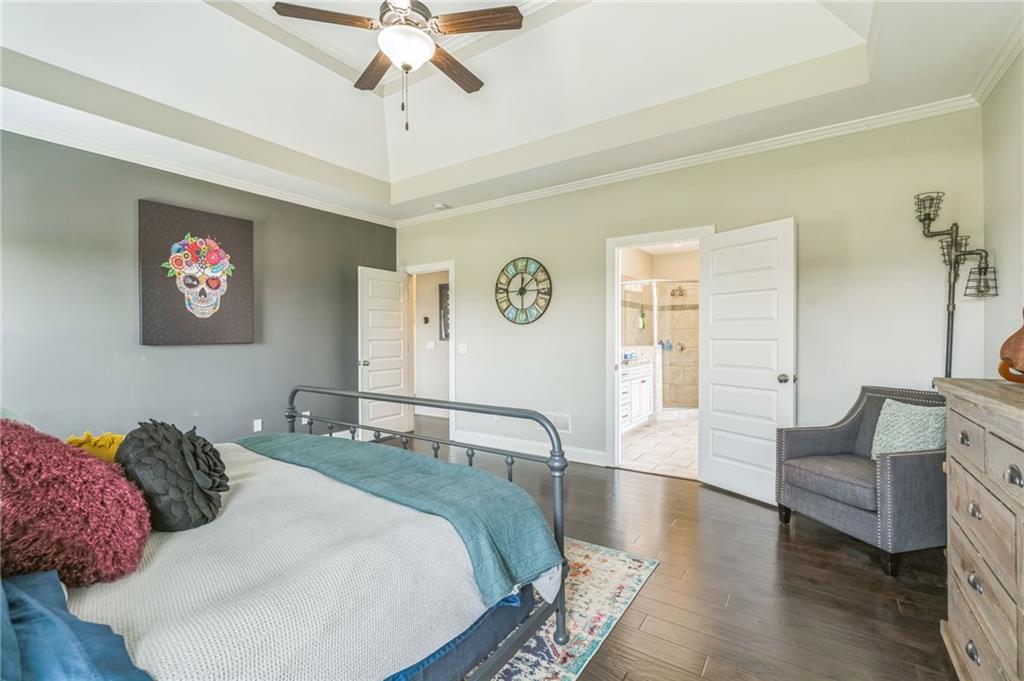 1621 Highland Creek Drive Monroe, GA 30656 - Photo 19 of 54 a bedroom with a bed and a chandelier