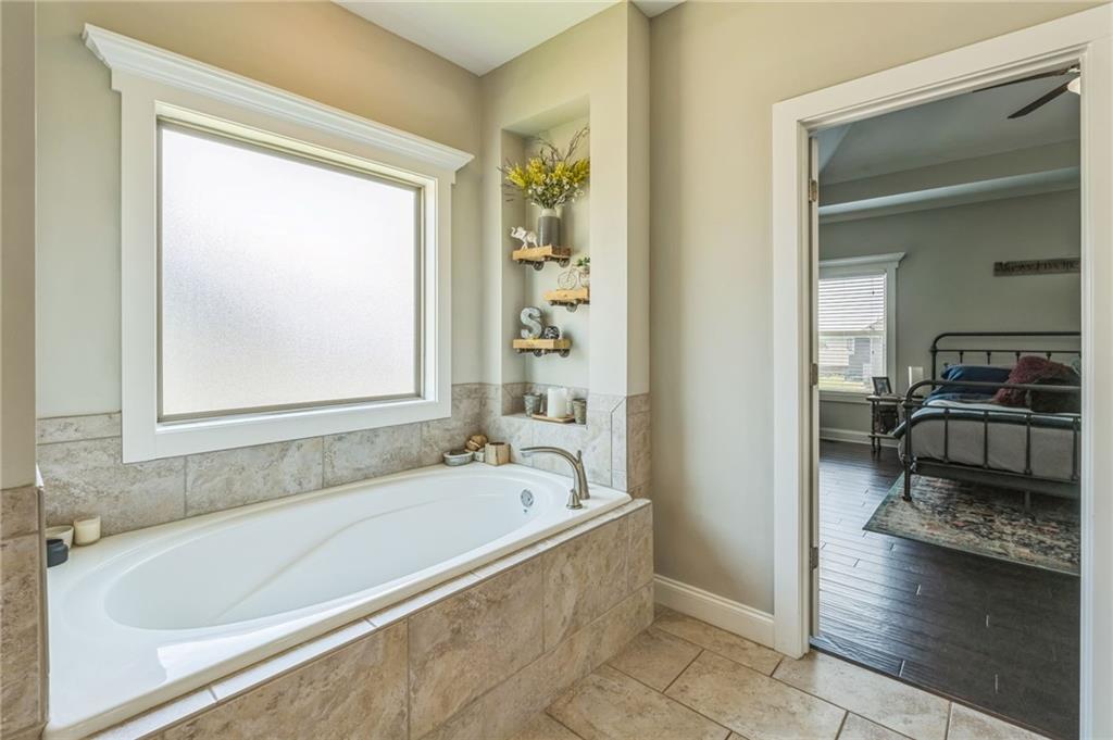 1621 Highland Creek Drive Monroe, GA 30656 - Photo 20 of 54 a bathroom with a bathtub and a shower
