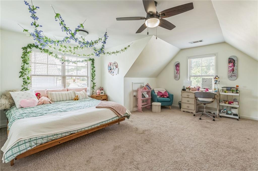 1621 Highland Creek Drive Monroe, GA 30656 - Photo 25 of 54 a bedroom with a bed and a chandelier