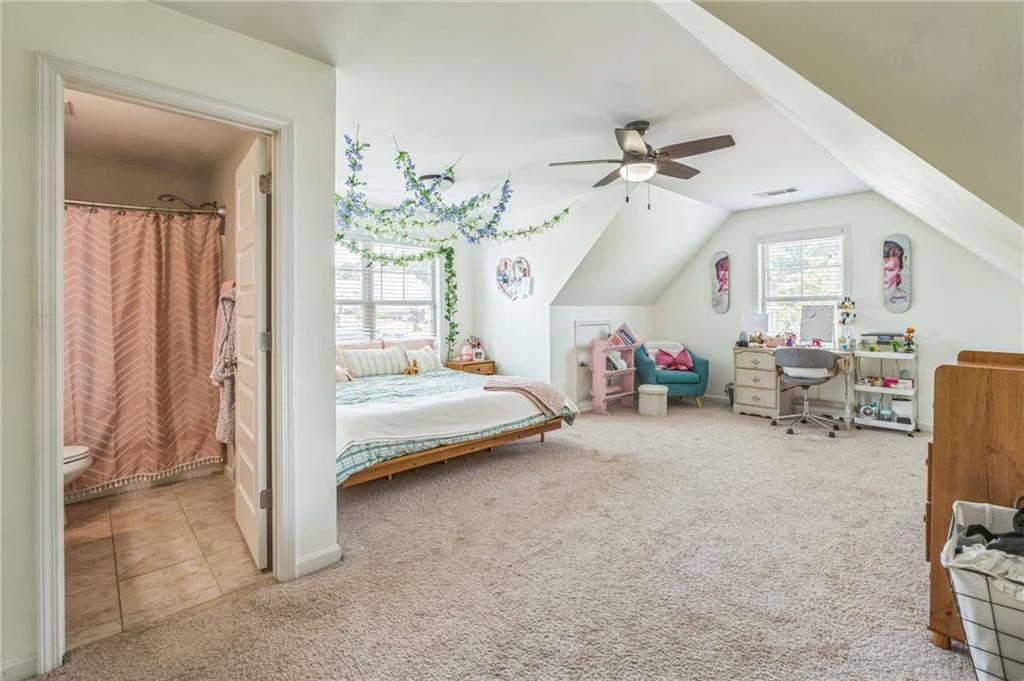 1621 Highland Creek Drive Monroe, GA 30656 - Photo 26 of 54 a bedroom with furniture and a chandelier