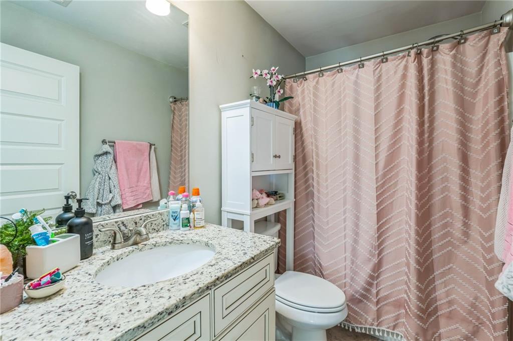 1621 Highland Creek Drive Monroe, GA 30656 - Photo 27 of 54 a bathroom with a granite countertop sink and a mirror