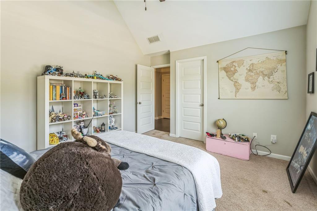 1621 Highland Creek Drive Monroe, GA 30656 - Photo 29 of 54 a bedroom with a bed and a painting on the wall
