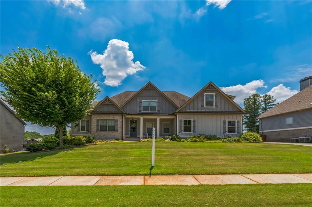 1621 Highland Creek Drive Monroe, GA 30656 - Photo 3 of 54 a front view of a house with a garden