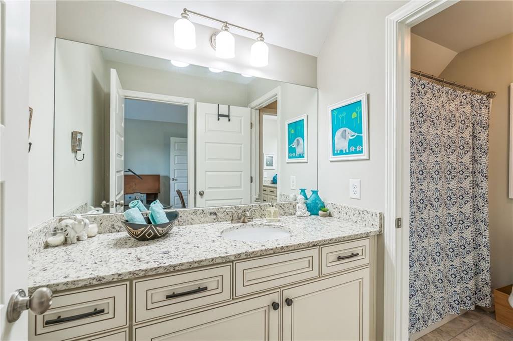 1621 Highland Creek Drive Monroe, GA 30656 - Photo 34 of 54 a bathroom with a granite countertop sink and a mirror