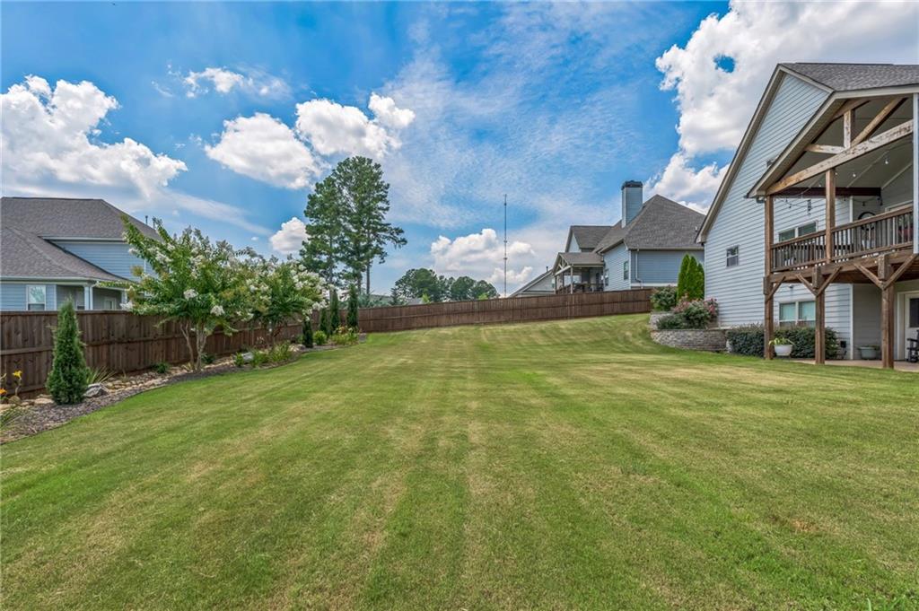 1621 Highland Creek Drive Monroe, GA 30656 - Photo 37 of 54 a backyard of a house with lots of green space