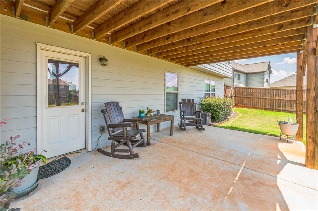 1621 Highland Creek Drive Monroe, GA 30656 - Photo 39 of 54 a view of a patio with table and chairs and potted plants