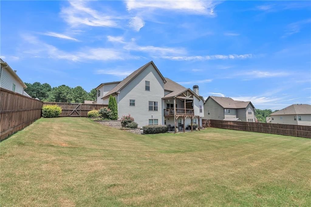 1621 Highland Creek Drive Monroe, GA 30656 - Photo 43 of 54 a view of a house with a yard and garage