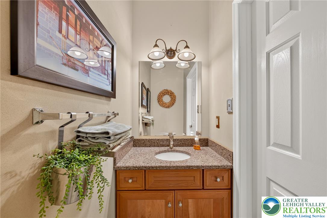 1702 Red Bud Road Quakertown, PA 18951 - Photo 26 of 68 A refined bathroom features a rich wood vanity with granite counters and a clean white sink.