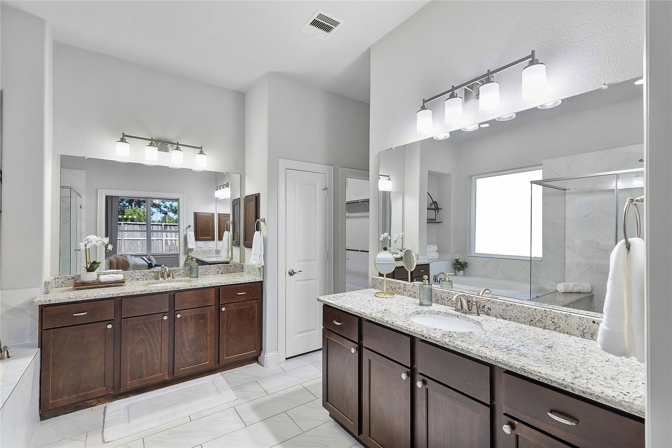 29539 Monona Terrace Court Spring, TX 77386 - Photo 25 of 50 Welcome to your primary bath suite with his and hers sinks, a large shower (with bench), and a soaking tub. *Staged furniture and accessories do not convey with the home*