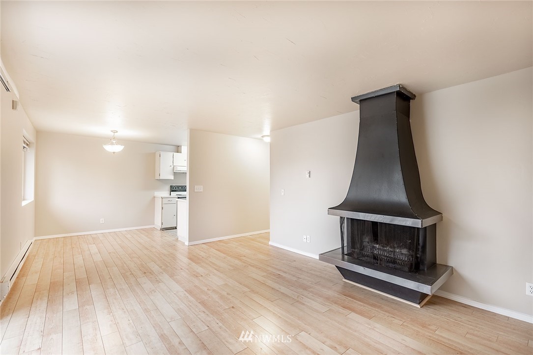 1601 Maple Lane, Unit A2 Kent, WA 98030 - Photo 12 of 27 a view of empty room with wooden floor and fireplace