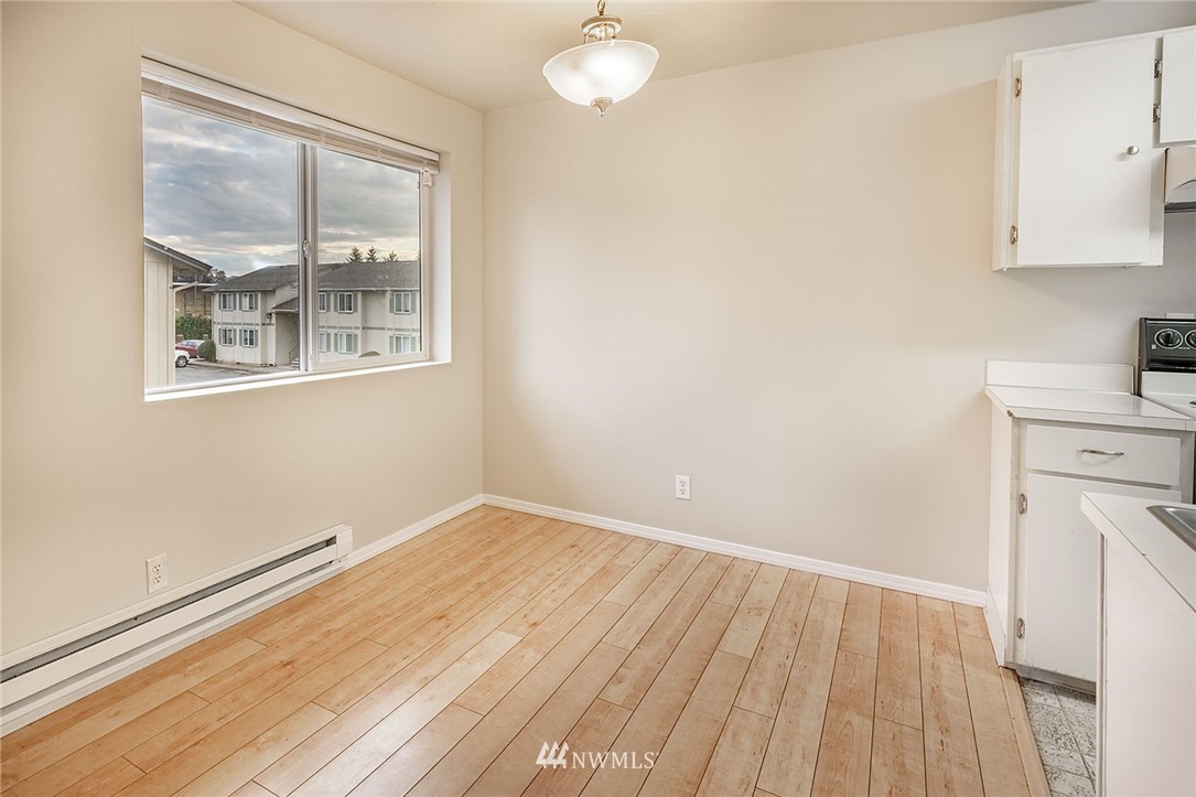 1601 Maple Lane, Unit A2 Kent, WA 98030 - Photo 13 of 27 a view of empty room with wooden floor and fan