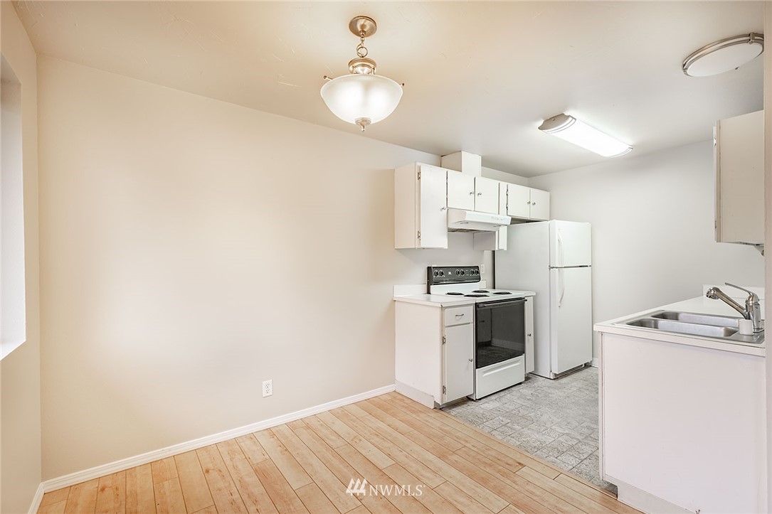 1601 Maple Lane, Unit A2 Kent, WA 98030 - Photo 14 of 27 a kitchen with a sink cabinets stainless steel appliances and a window