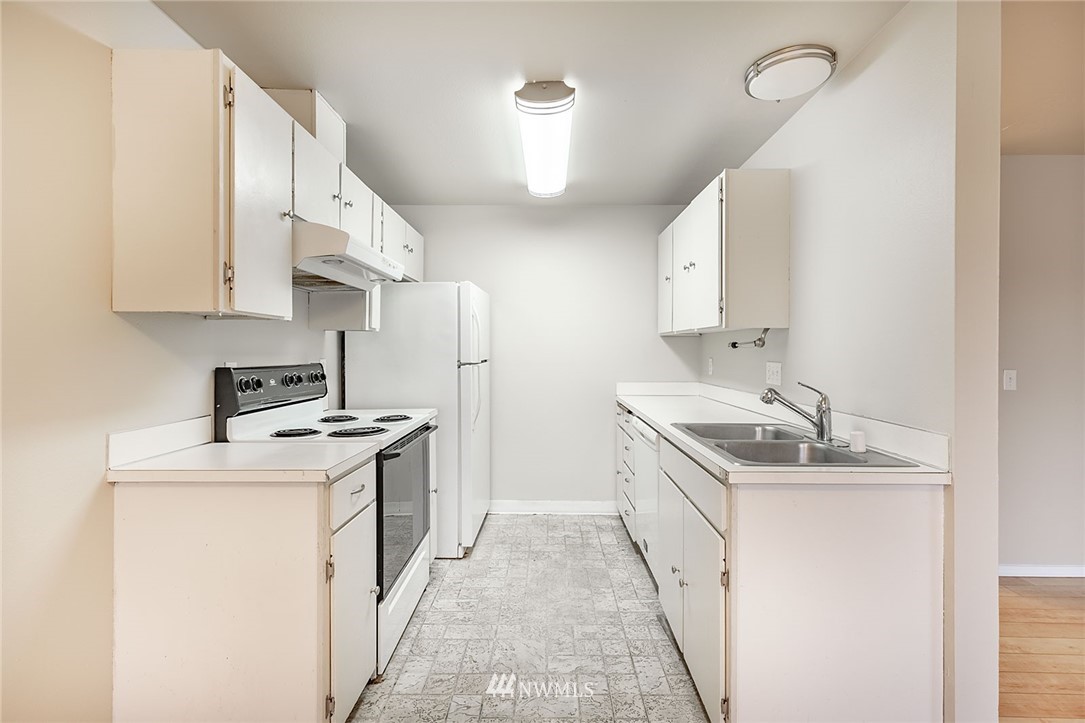 1601 Maple Lane, Unit A2 Kent, WA 98030 - Photo 15 of 27 a kitchen with a sink stove and cabinets
