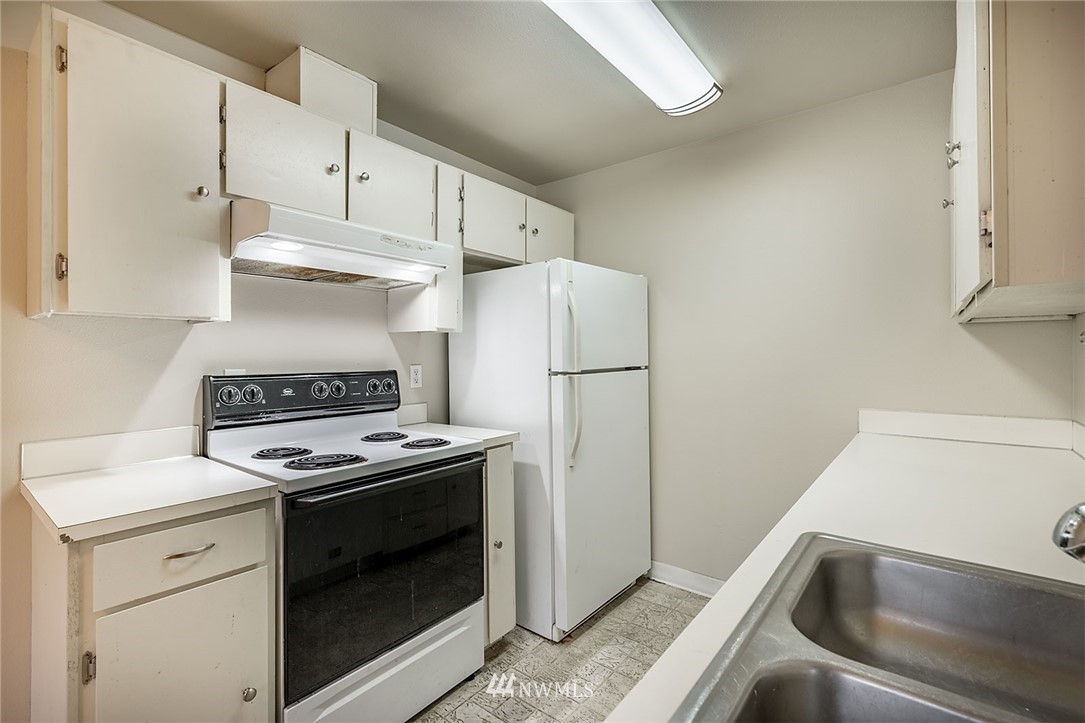 1601 Maple Lane, Unit A2 Kent, WA 98030 - Photo 16 of 27 a kitchen with white cabinets and white appliances
