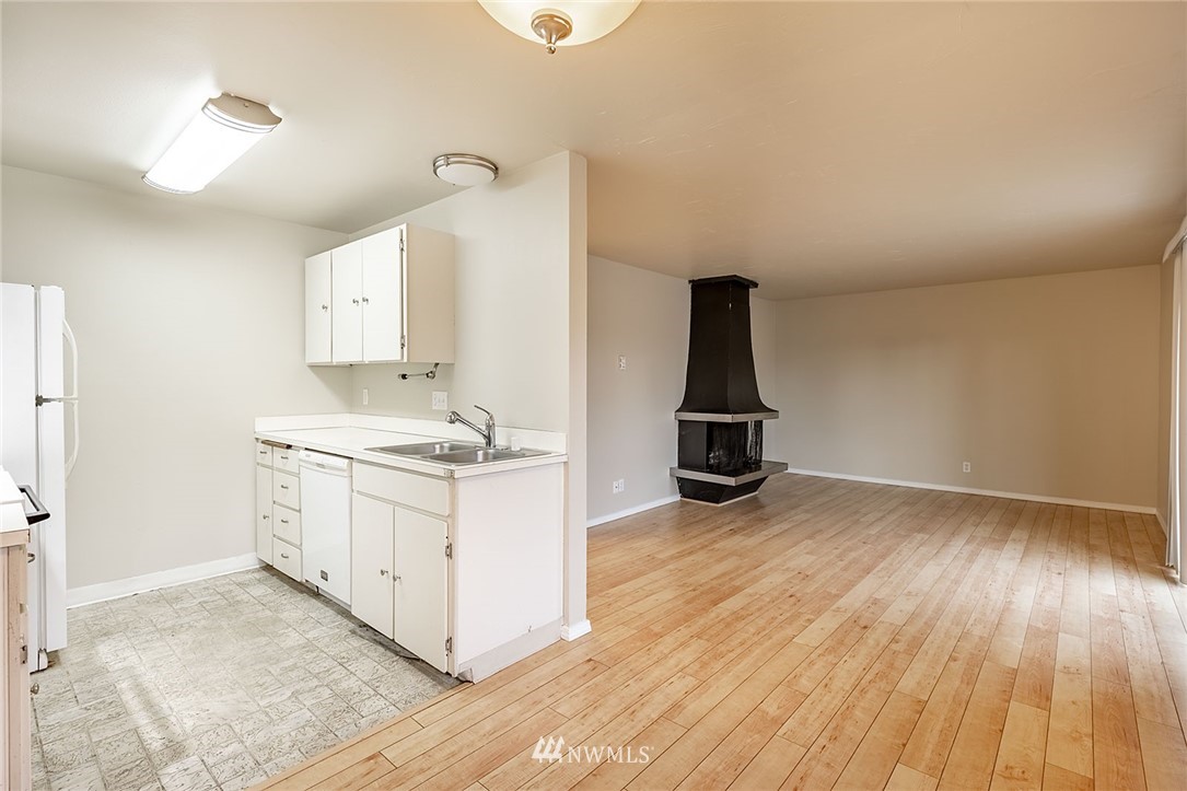 1601 Maple Lane, Unit A2 Kent, WA 98030 - Photo 18 of 27 a view of a kitchen with wooden floor and electronic appliances