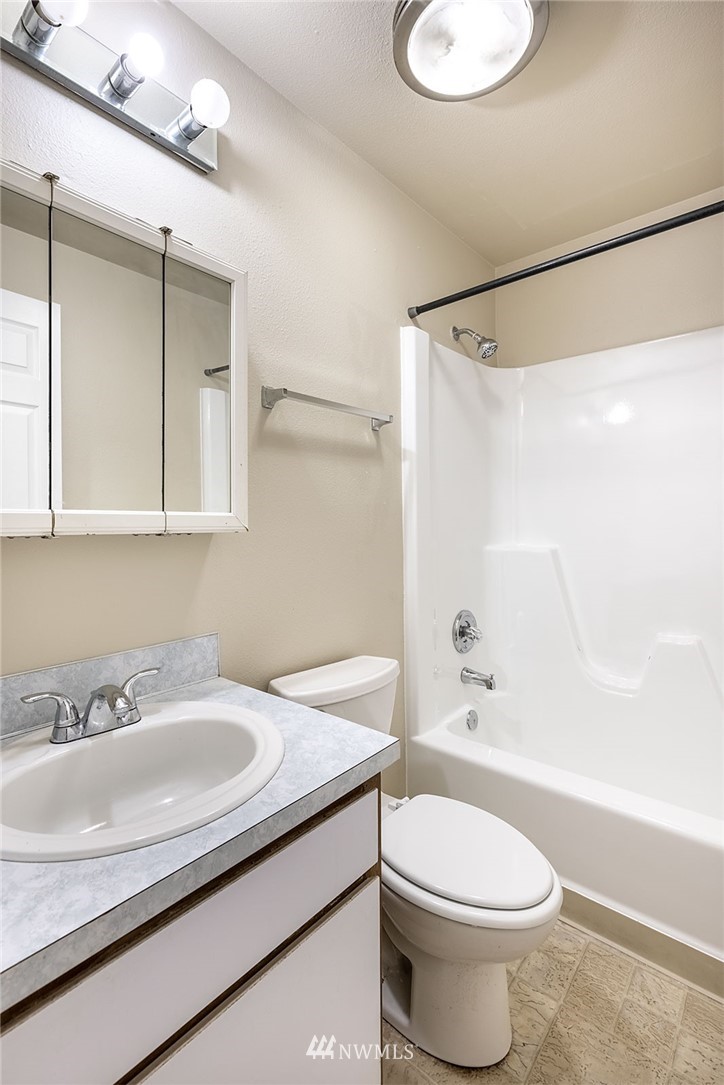 1601 Maple Lane, Unit A2 Kent, WA 98030 - Photo 23 of 27 a bathroom with a sink a toilet and shower