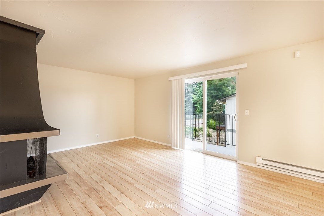 1601 Maple Lane, Unit A2 Kent, WA 98030 - Photo 7 of 27 a view of an empty room with wooden floor and a window