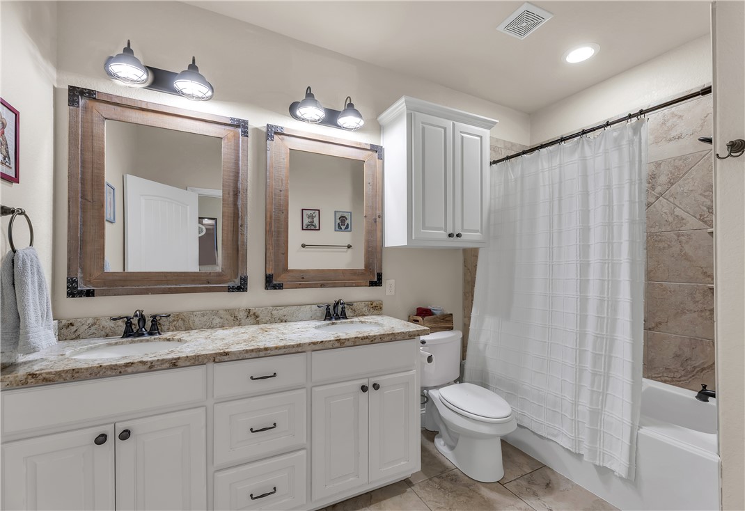 8312 Raintree Drive College Station, TX 77845 - Photo 22 of 30 Double vanity featuring granite countertops and undermount sinks