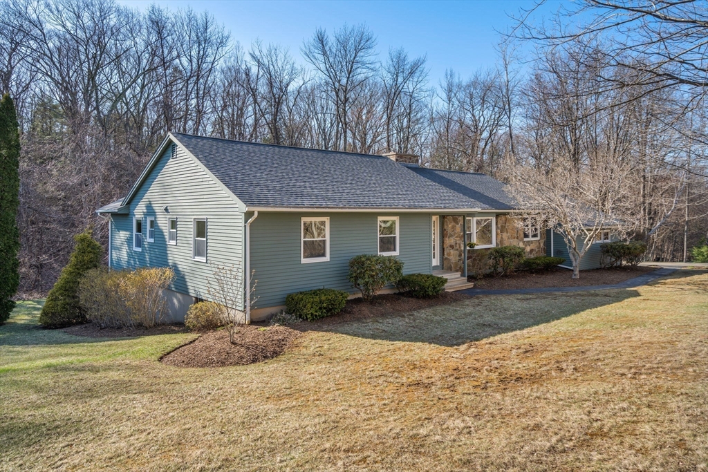 37 Finlay Road Sturbridge, MA 01518 - Photo 1 of 39 a front view of a house with a yard and trees