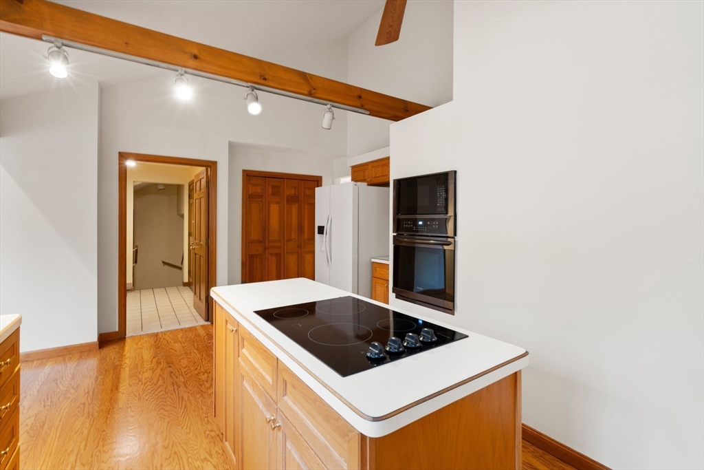 37 Finlay Road Sturbridge, MA 01518 - Photo 19 of 39 a kitchen with stainless steel appliances a stove a microwave and a refrigerator with wooden floor