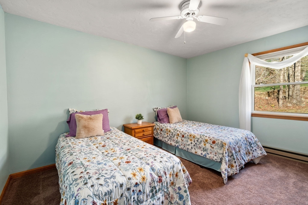 37 Finlay Road Sturbridge, MA 01518 - Photo 27 of 39 a bedroom with two beds and a chandelier