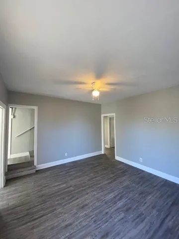 a view of an empty room with wooden floor