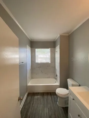a bathroom with a toilet a sink and bathtub