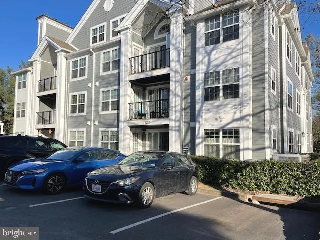 a couple of cars parked in front of a building