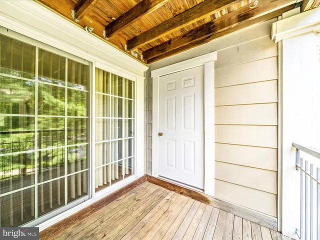 a view of a porch with wooden floor