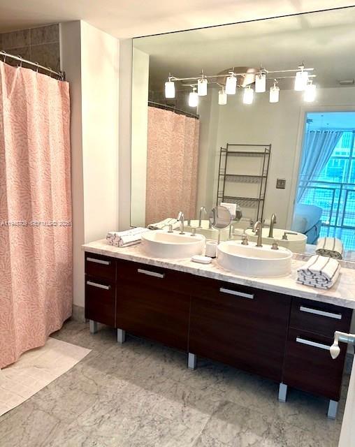 253 Northeast 2nd Street, Unit 421 Miami, FL 33132 - Photo 12 of 15 a bathroom with a sink and a mirror