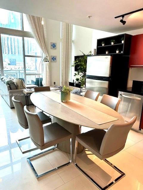 253 Northeast 2nd Street, Unit 421 Miami, FL 33132 - Photo 13 of 15 a dining room with furniture and window