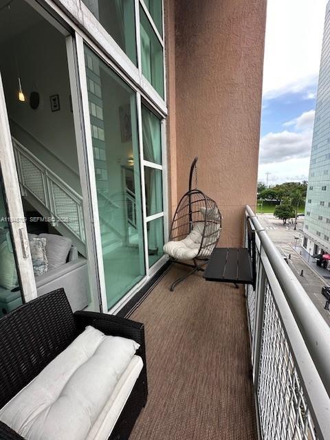 253 Northeast 2nd Street, Unit 421 Miami, FL 33132 - Photo 15 of 15 a view of a balcony with chair and wooden floor