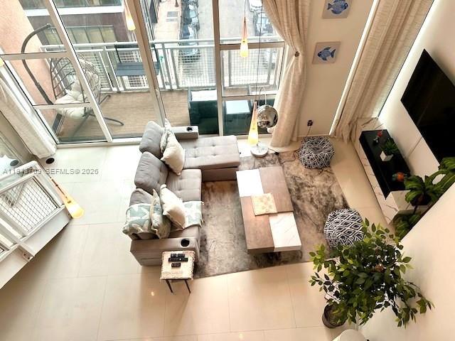 253 Northeast 2nd Street, Unit 421 Miami, FL 33132 - Photo 3 of 15 a living room with furniture and a flat screen tv