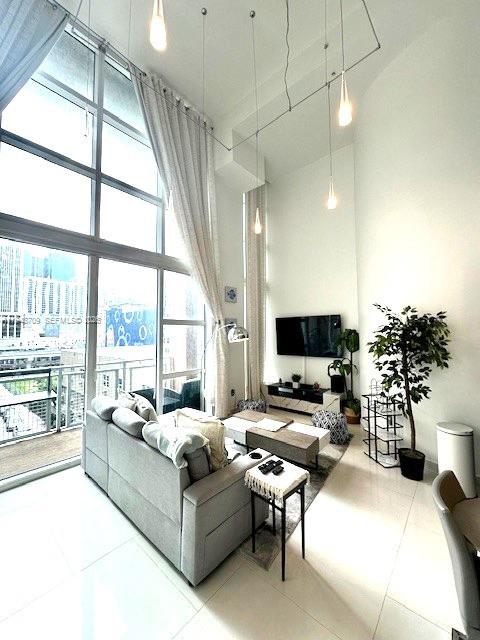 253 Northeast 2nd Street, Unit 421 Miami, FL 33132 - Photo 5 of 15 a living room with furniture and a large window