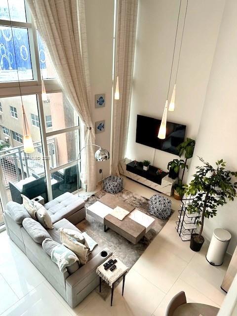 253 Northeast 2nd Street, Unit 421 Miami, FL 33132 - Photo 8 of 15 a living room with furniture and a window