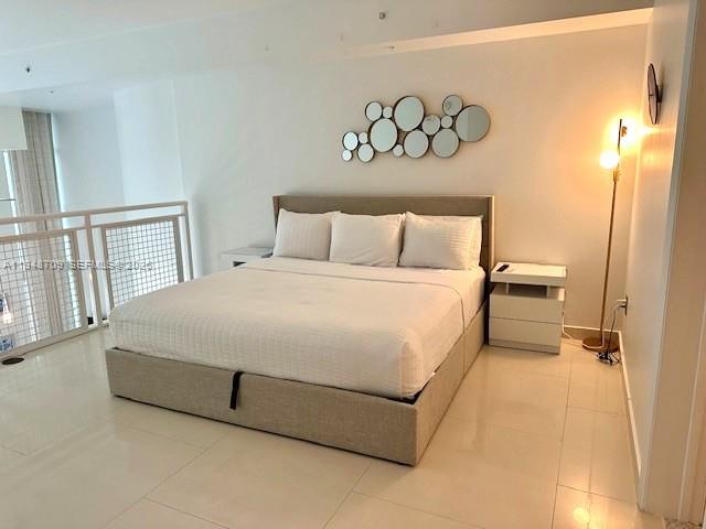 253 Northeast 2nd Street, Unit 421 Miami, FL 33132 - Photo 10 of 15 a large bed sitting in a bedroom next to a window